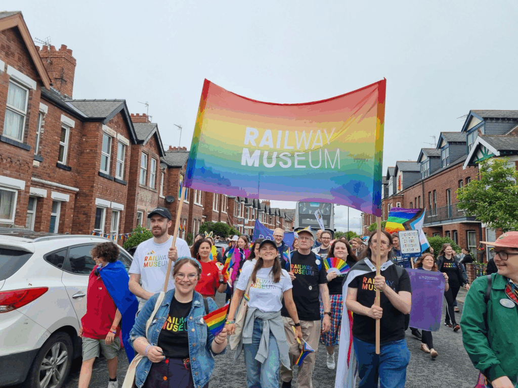 Railway Museum colleagues marching with a Pride banner for York's 2025 Pride Parade.