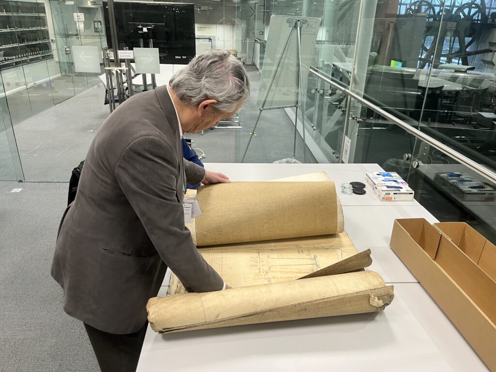 Man leant over desk looking at an engineering drawing