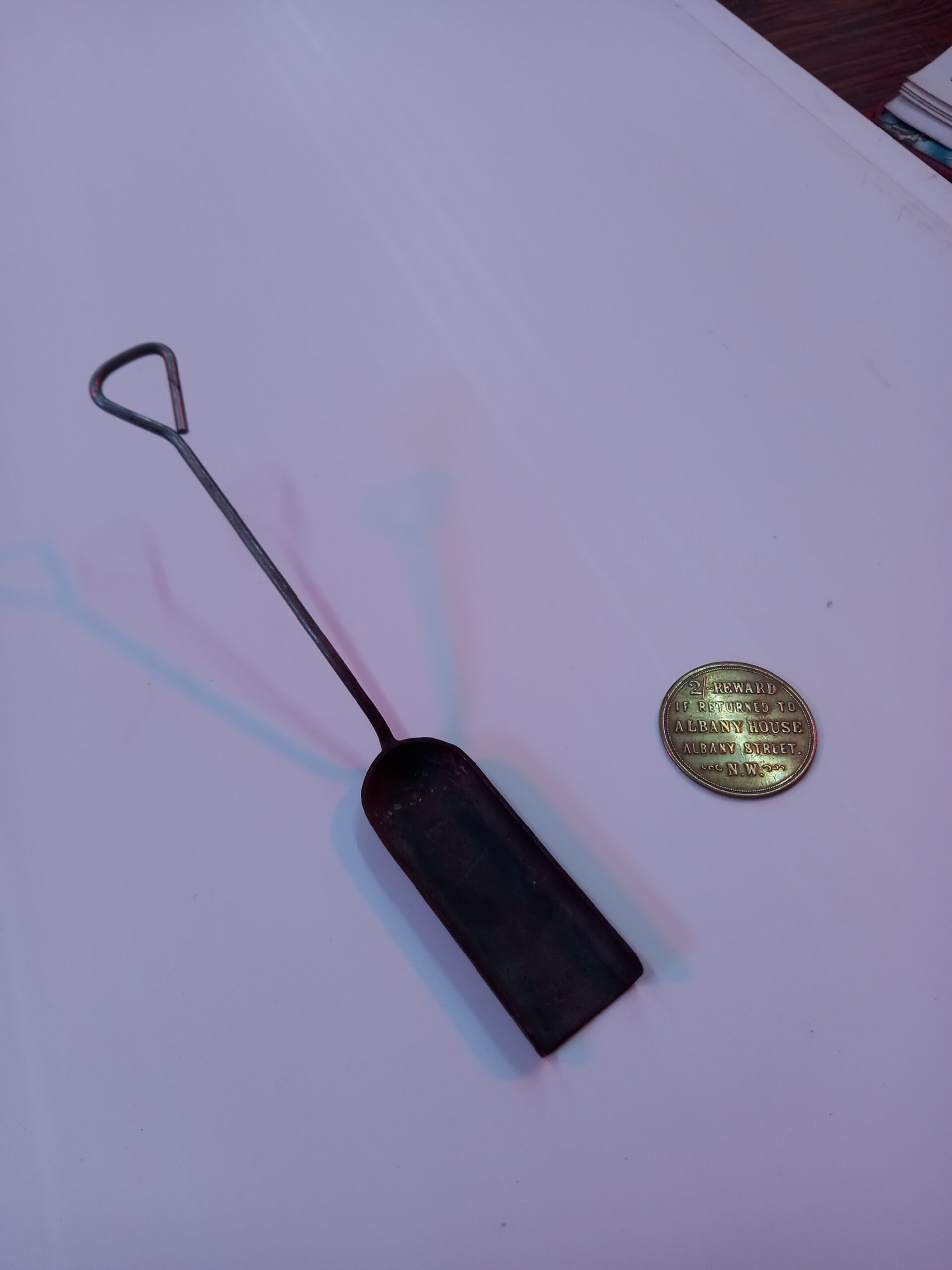 Curly's coal shovel & bus token.